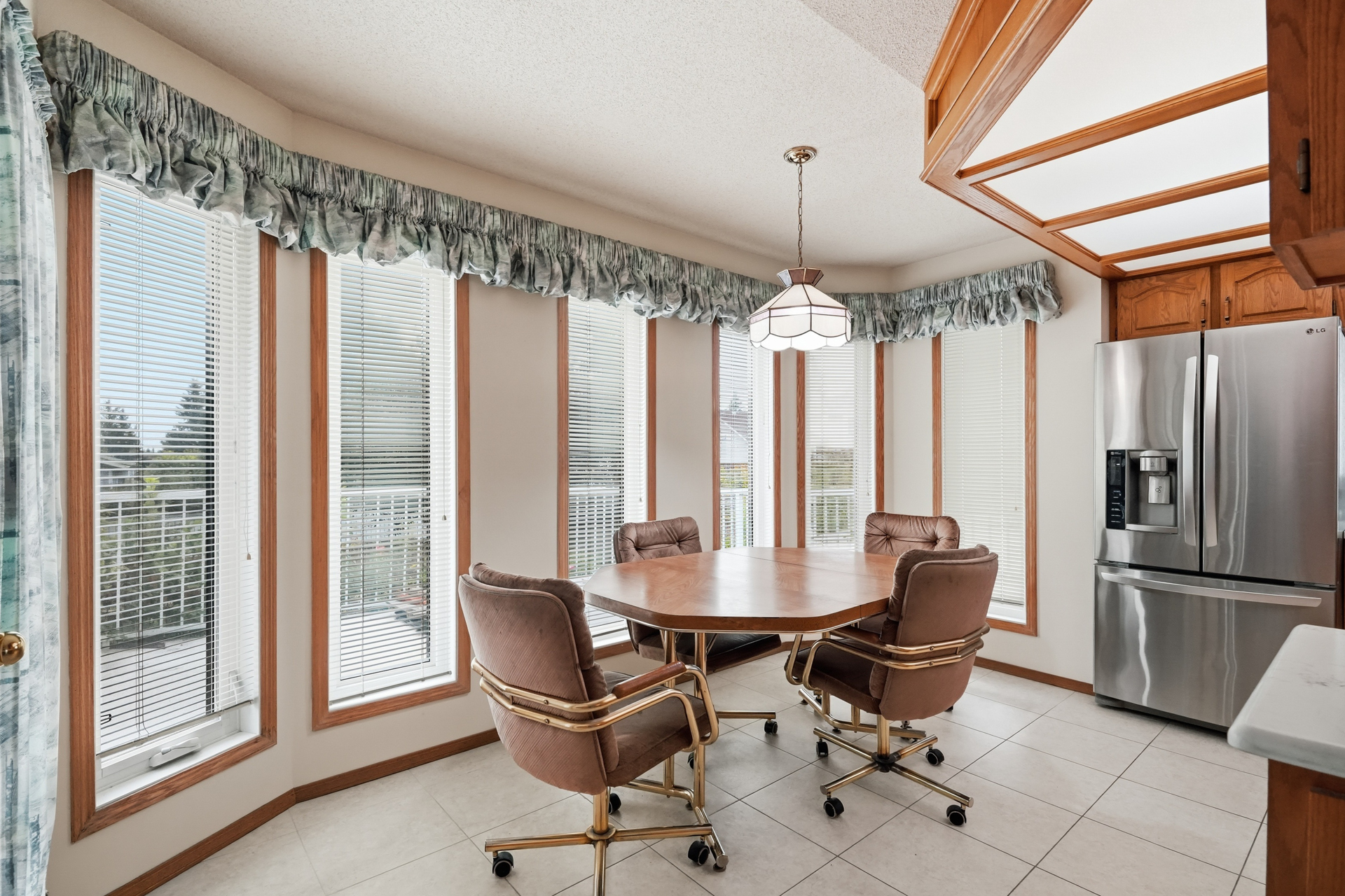 Sunny dining nook surrounded by windows