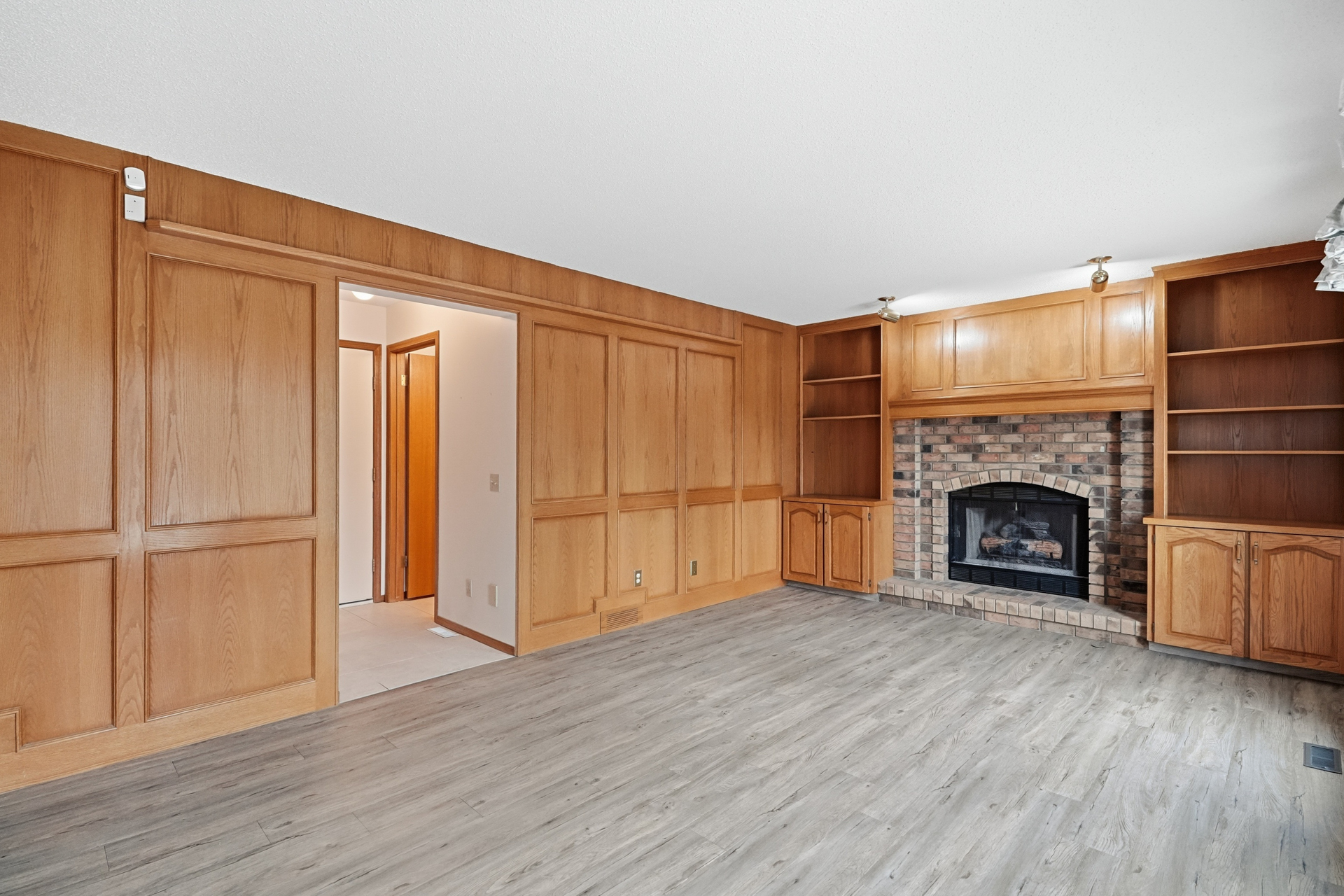 Family room with brick fireplace and built-in cabinetry